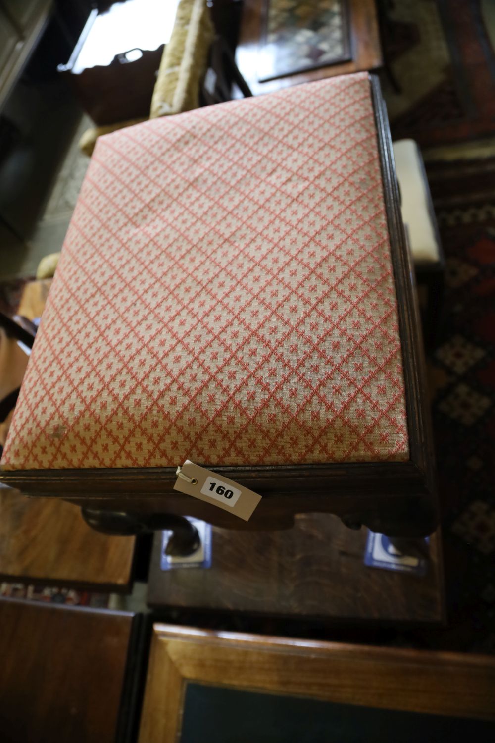 A George III mahogany box stool, the hinged lid with upholstered top above shaped apron and cabriole knees, on pointed pad feet, width